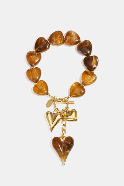 Beaded bracelet with hanging heart charms